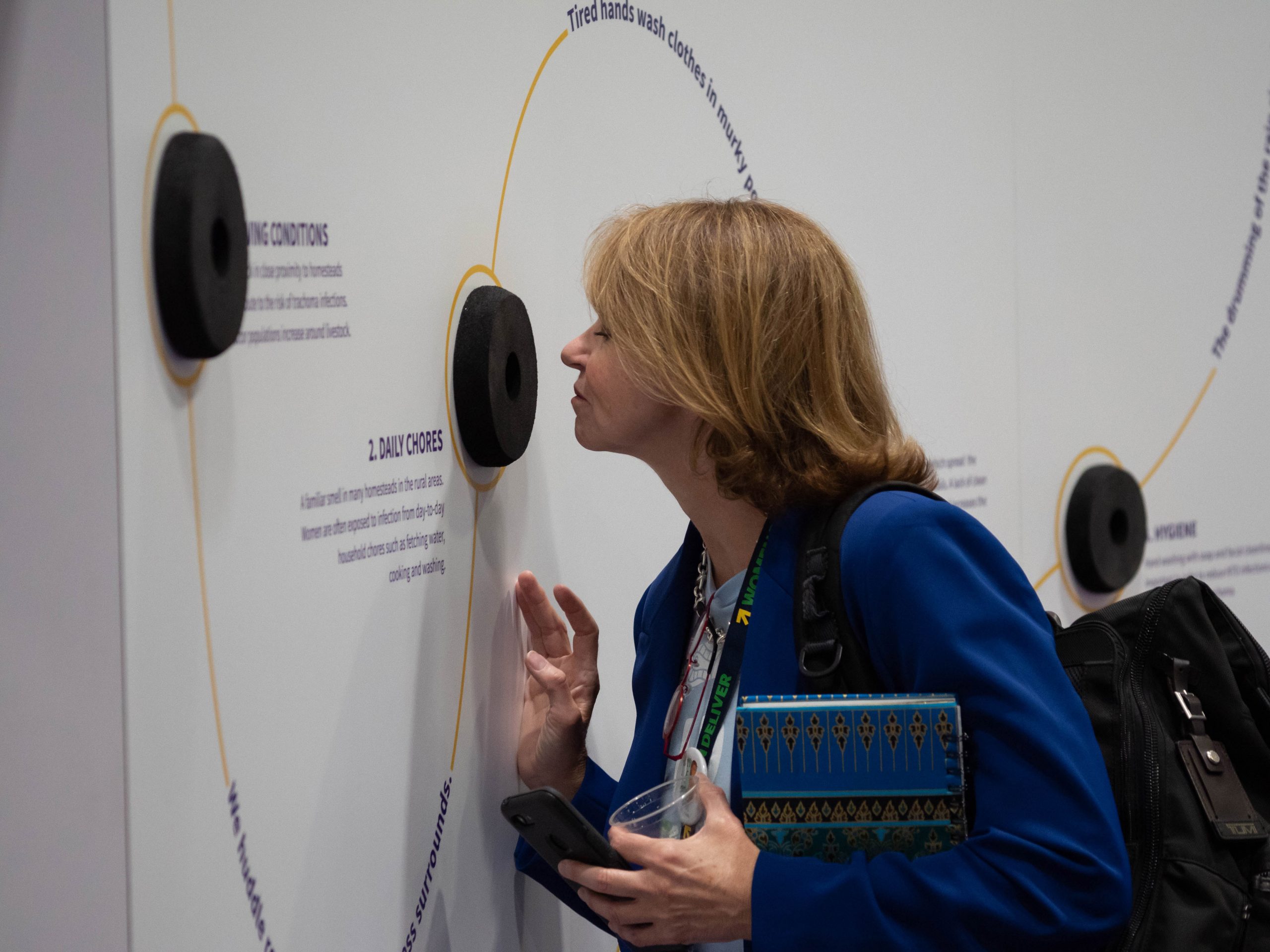 Women Deliver 2019 -image 5 - a woman trying out the interactive exhibition stand
