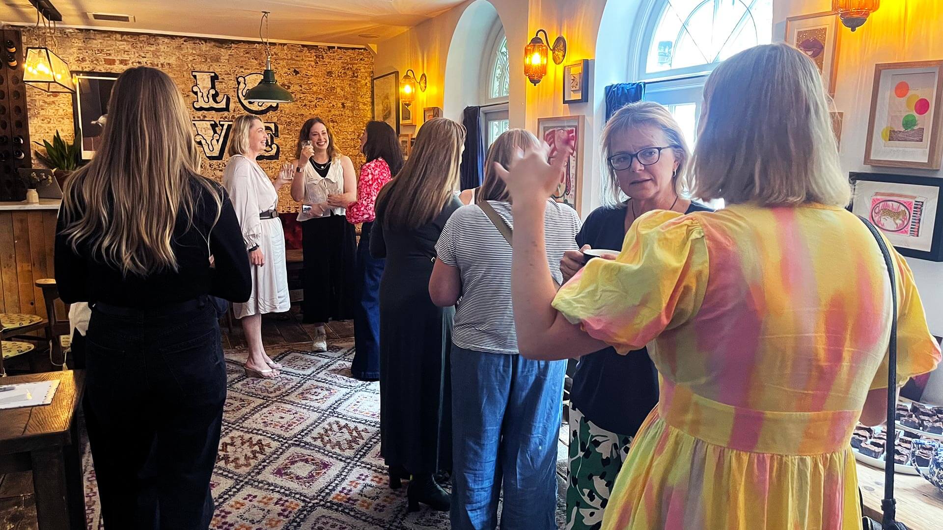 MOREVER Meetup image of a group of senior women from the charity sector chatting and networking