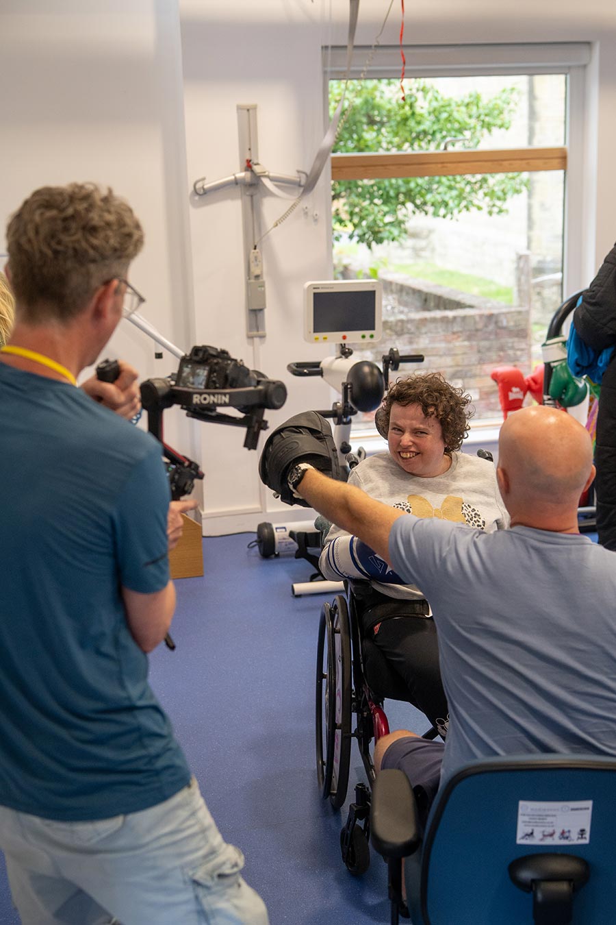 MOREVER videographer capturing Chailey Activity Place user in a exercise session using boxing gloves and pads