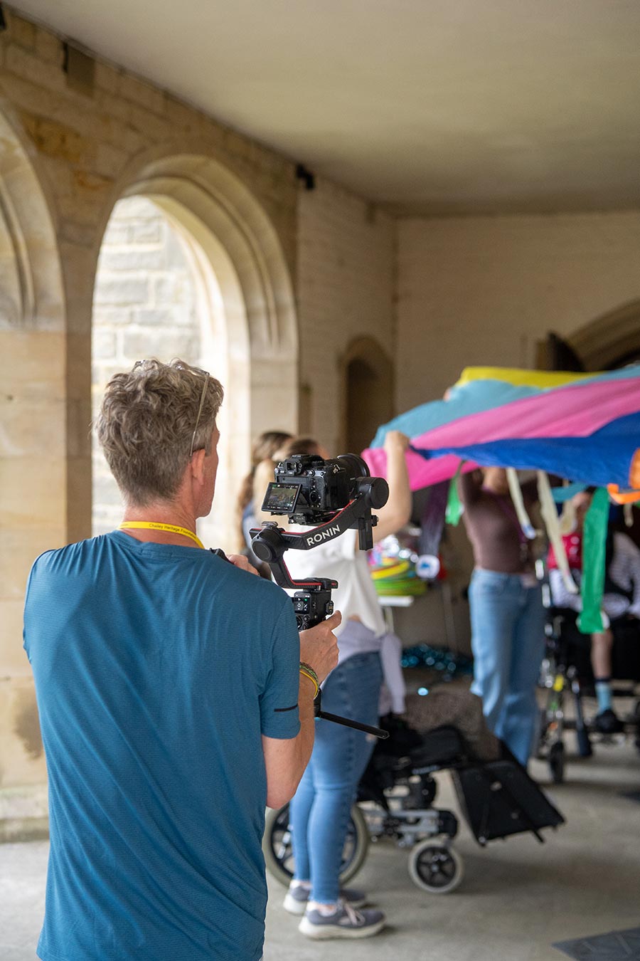 MOREVER videographer capturing Chailey students taking part in a sensory activity using a brightly coloured parachute