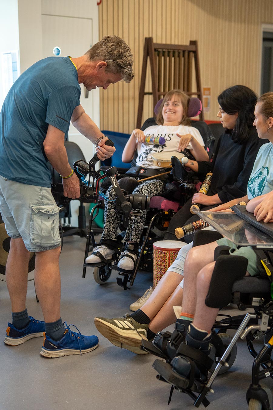 MOREVER videographer filming Chailey Heritage Foundation participants taking part in a drumming session